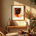 Framed african art print of a woman on a wall above a wooden shelf with decorative items.