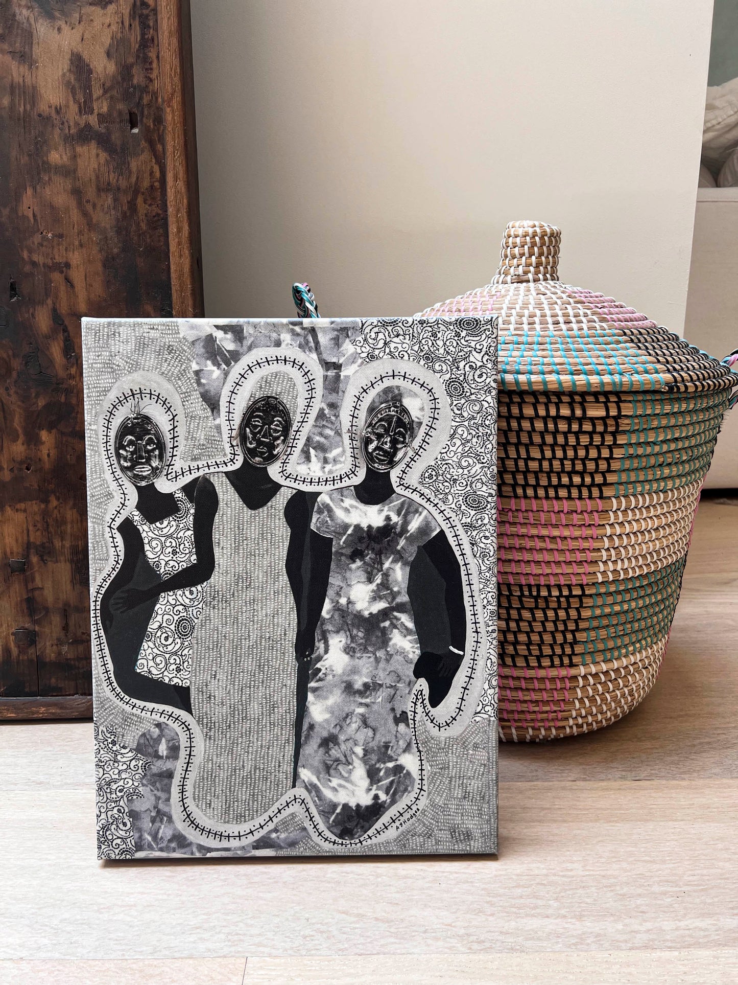 African American art print 'Mirror Mirror' by Antionette Simmons Hodges on Gray Fabric,  depicts 3 woman with Afrocentric faces . shown in a living room