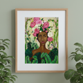 Framed artwork of a woman with floral headpiece and green leaves on a light green wall.