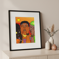 Framed artwork of three figures with a colorful background on a shelf with decorative vases.