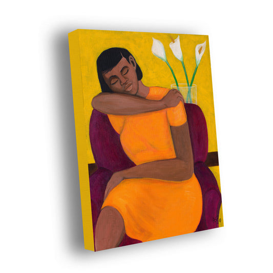 Stretched canvas print titled 'A Quiet Moment' by Antionette Simmons Hodges. The artwork depicts a woman with her eyes closed, seated in a muted purple chair, embracing herself while wearing a vibrant orange dress. The background is a warm yellow, and beside her, a vase holds three white calla lilies, symbolizing purity and peace. The scene conveys solitude and introspection, inviting a sense of tranquility and calm.