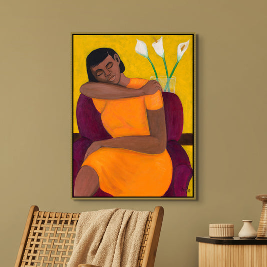 A Quiet Moment framed canvas print by Antionette Simmons Hodges. Depicts a woman in a vibrant orange dress seated in a purple chair, embracing tranquility. Perfect for adding a serene, introspective touch to any space.