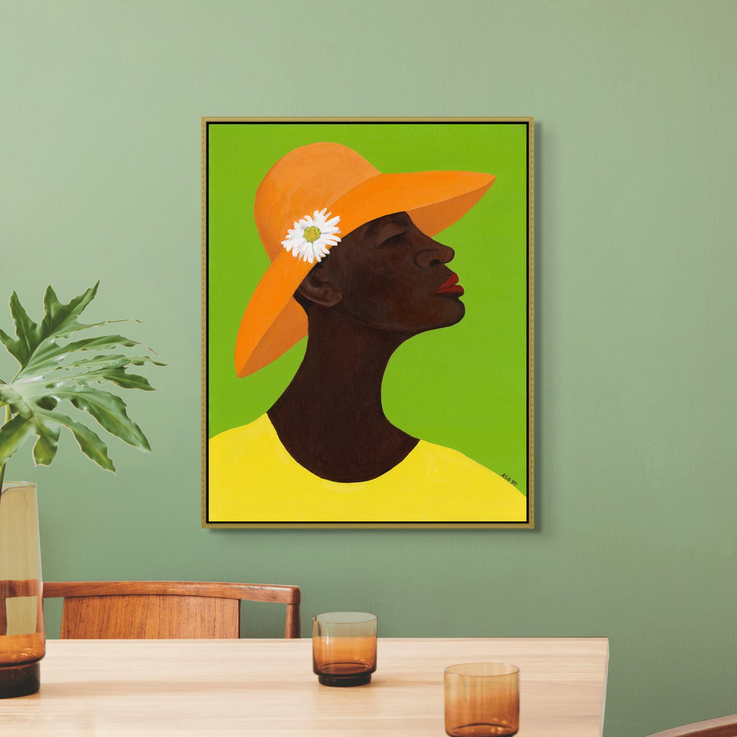 Annabelle's New Hat framed canvas print by Antionette Simmons Hodges. Features an African American woman in a vibrant orange hat with a white daisy, set against a green background. Celebrates elegance and cultural pride.