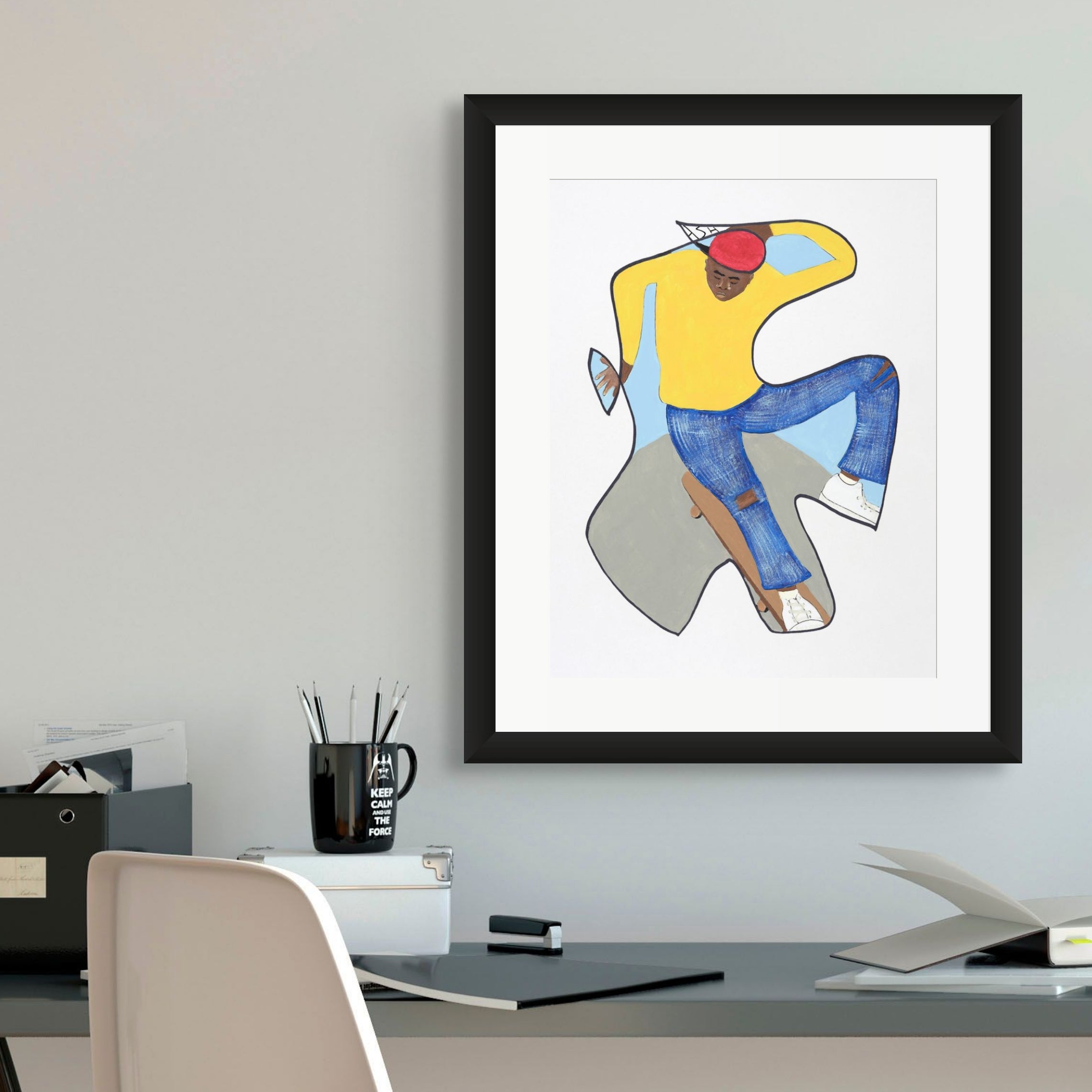 Betcha Can't Do This skateboard print framed in black, hung above a desk