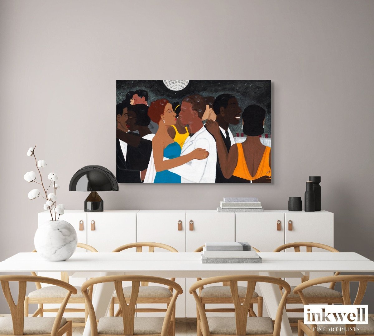 'Black Tie Affair' stretched canvas print: Couple in blue and yellow dress, white suit, surrounded by elegantly dressed figures against a monochromatic background, displayed above a white cabinet in a dining room.