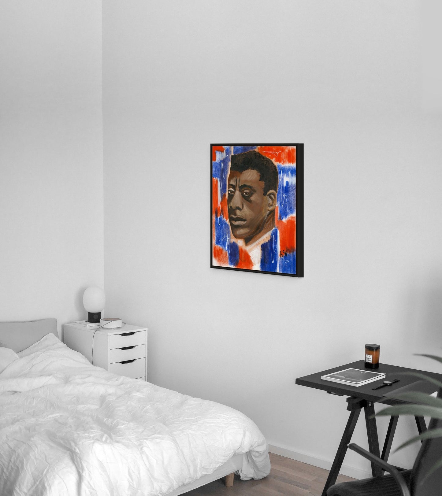 Framed stretched canvas print of 'Red, White & Blues - James Baldwin,' elegantly framed in black. The artwork showcases Baldwin against a dynamic red, white, and blue backdrop, celebrating his profound impact on literature and civil rights, with the black frame adding a sophisticated touch.