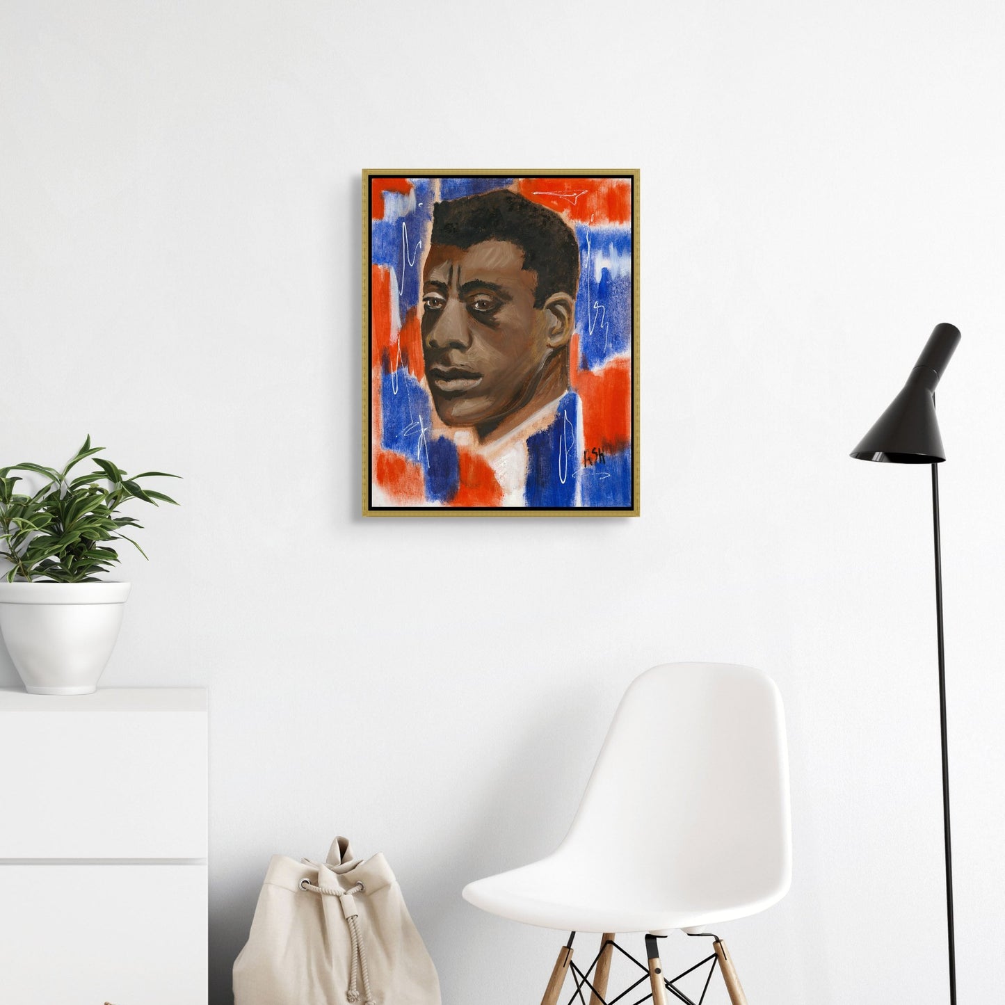 Framed stretched canvas print of 'Red, White & Blues - James Baldwin,' set in an elegant gold frame. The artwork features Baldwin against a vibrant red, white, and blue background, highlighting his impactful legacy in literature and civil rights, with the gold frame adding a touch of sophistication and warmth.