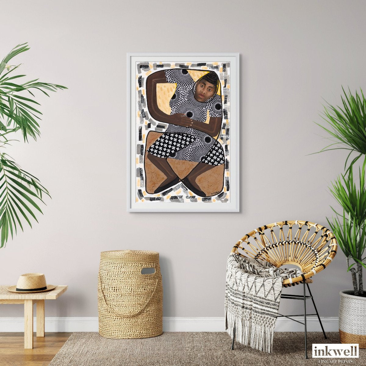 'How Low Can You Go?' art print: Stylized figure in a limbo dance pose with rich brown hues and black patterning, against an abstract background of dot patterns and floral motifs, displayed on a wall above a basket and a bohemian-style chair.