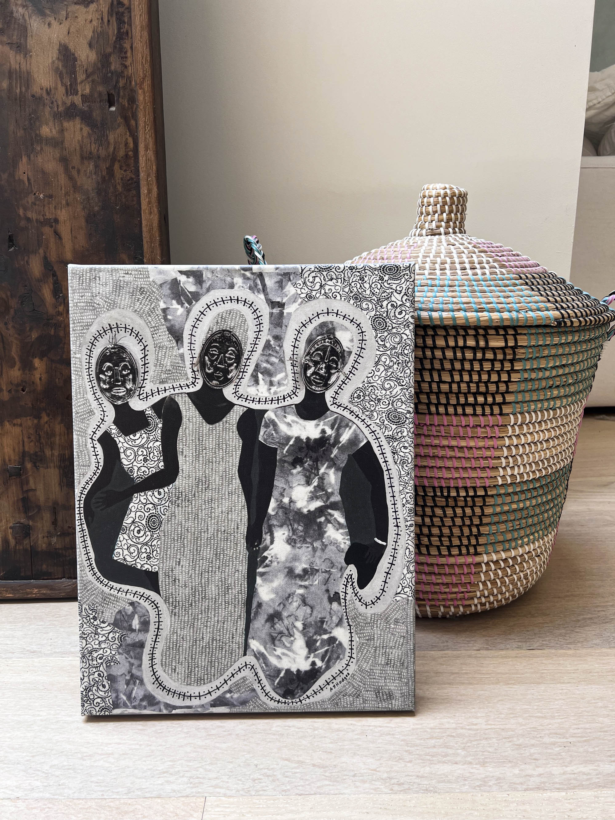 Mirror Mirror - Stretched Canvas Print - Ancestral African Masks Art - artwork next to straw basket with lid