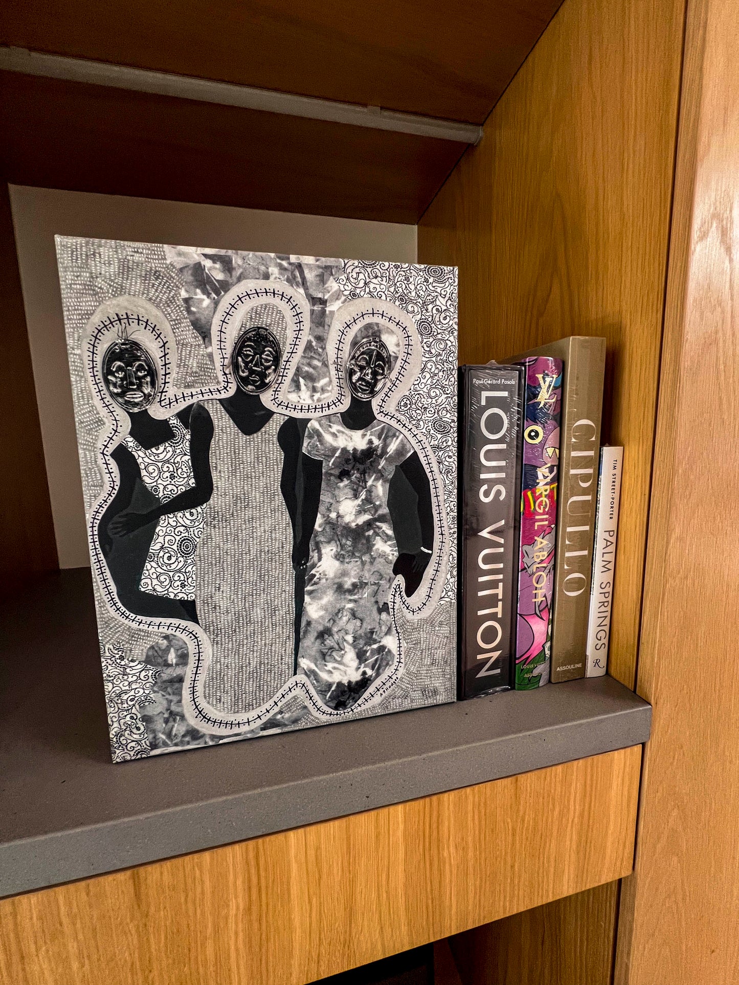 African American art print 'Mirror Mirror' by Antionette Simmons Hodges on Gray Fabric,  depicts 3 woman with Afrocentric faces  shown on a shelf with books