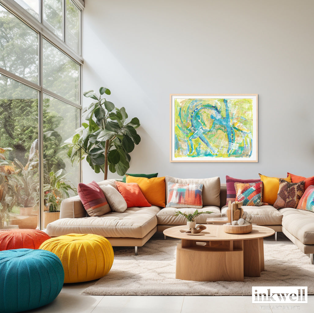 'Motion in Teal' art print: Abstract expressionist painting with swirling teal tones blended with lime green, copper, blue, and white, capturing dynamic movement and dance, featuring abstract dancer forms emerging from the brushstrokes. shown in living room with colorful pillows on top of a sofa.