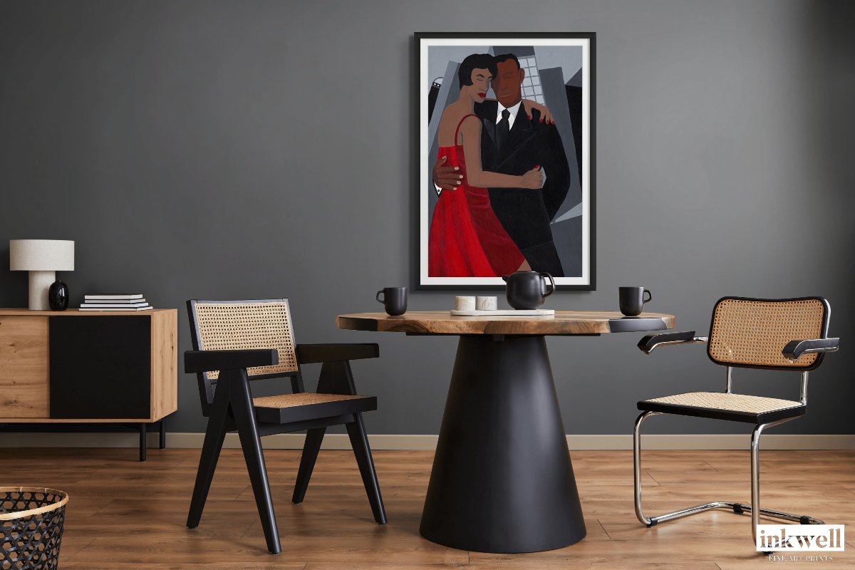 'Night on the Town' art print: Elegantly dressed couple, woman in a red dress and man in a black suit, embracing against a stylized urban backdrop with abstract buildings, capturing a romantic and celebratory evening atmosphere. hung on gray wall  above circular elegant dining table