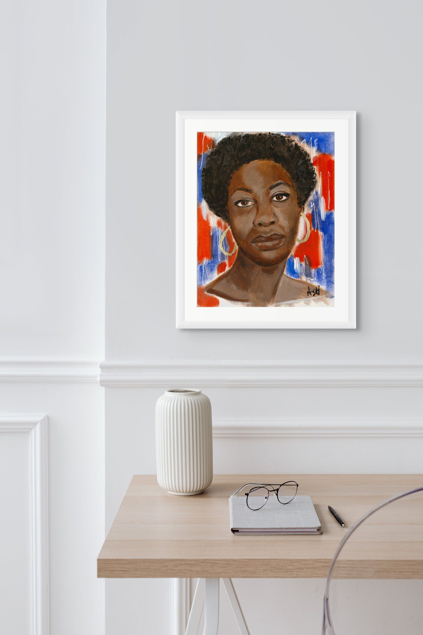 Portrait of Nina Simone in a sleek white frame with white matting. The image features bold red, white, and blue tones, highlighting her significant influence in music and civil rights, elegantly framed to enhance its vibrant presentation.