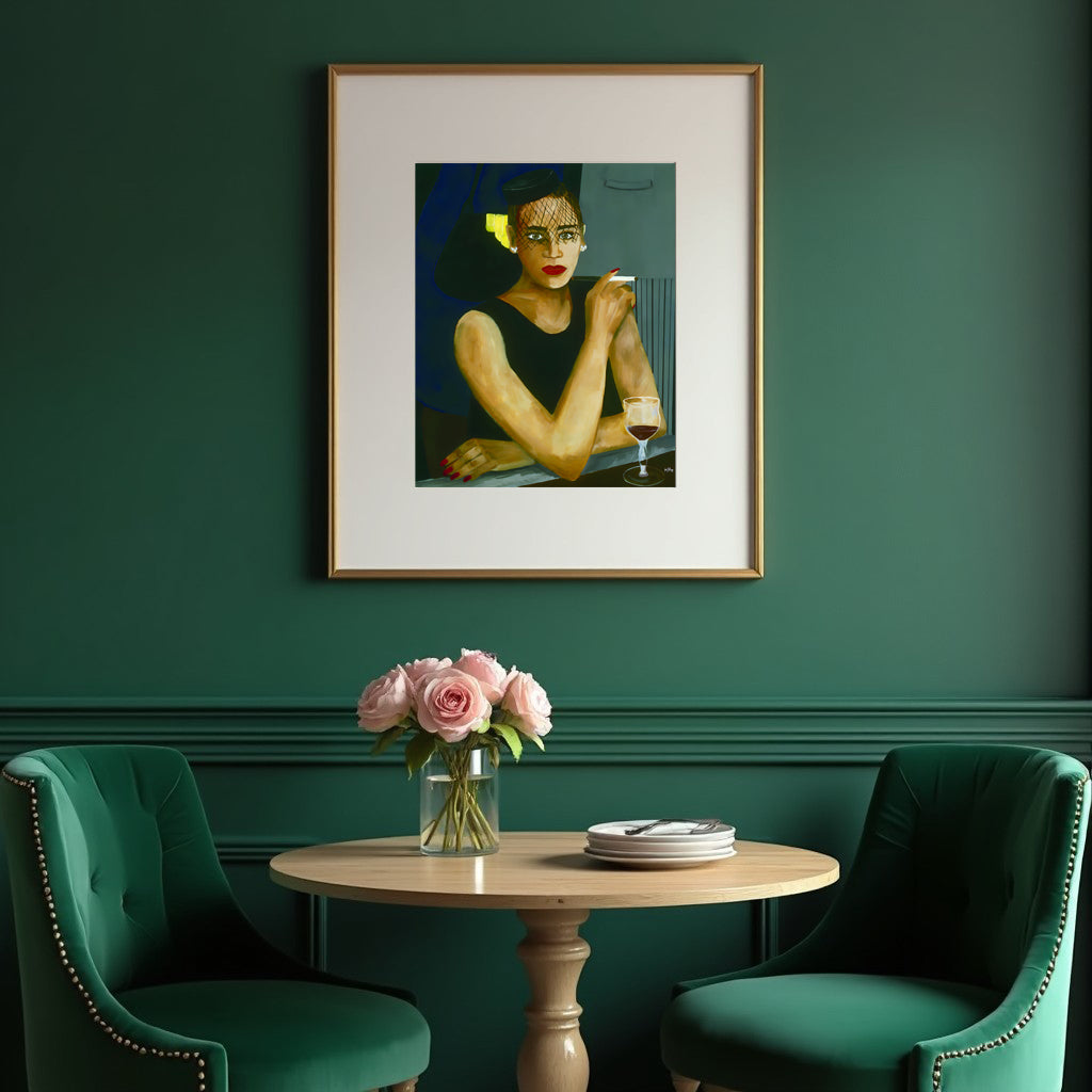 Framed artwork on a green wall above a table with flowers and plates, with two green chairs.
