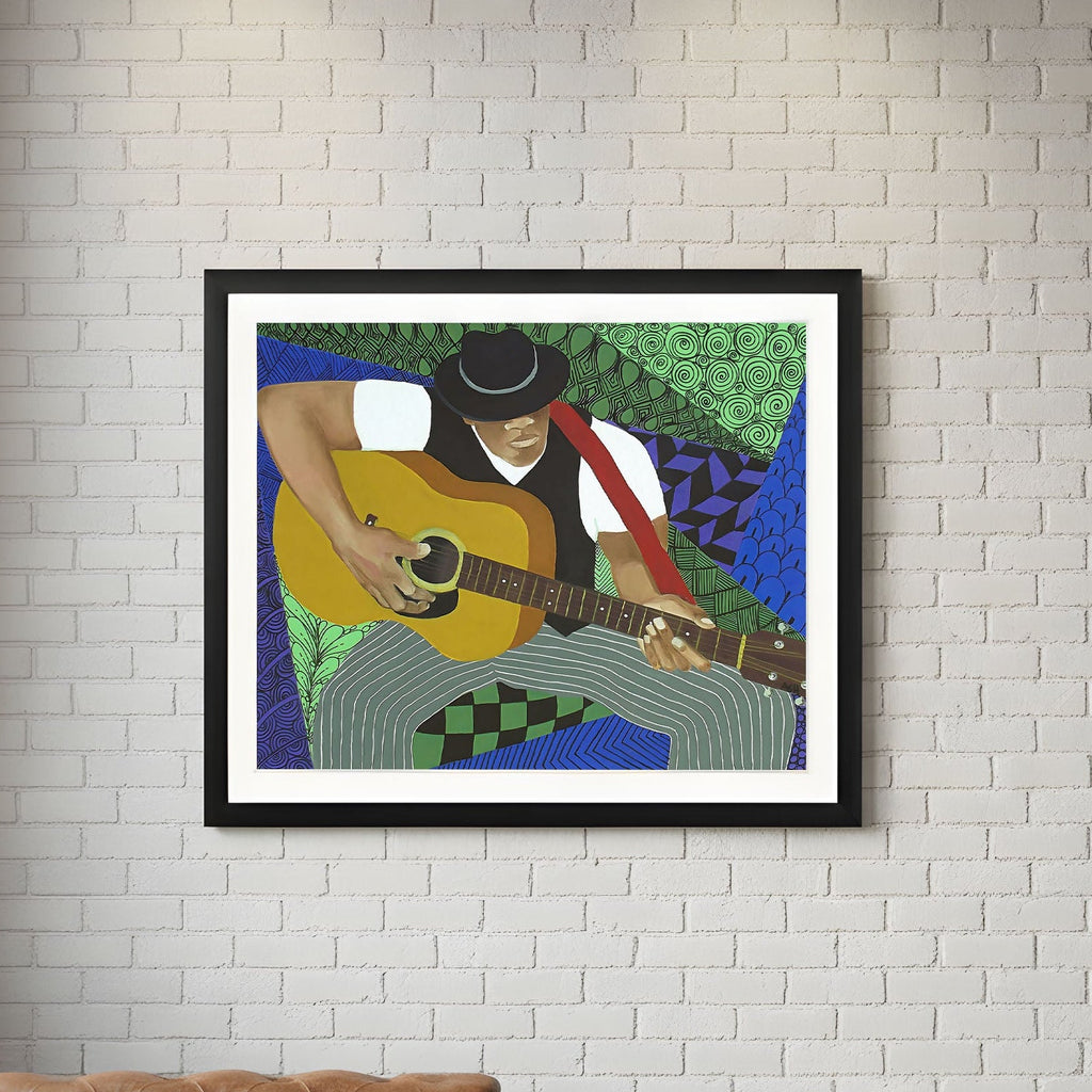 Framed artwork of a person playing guitar on a white brick wall with a brown leather sofa and wooden coffee table.