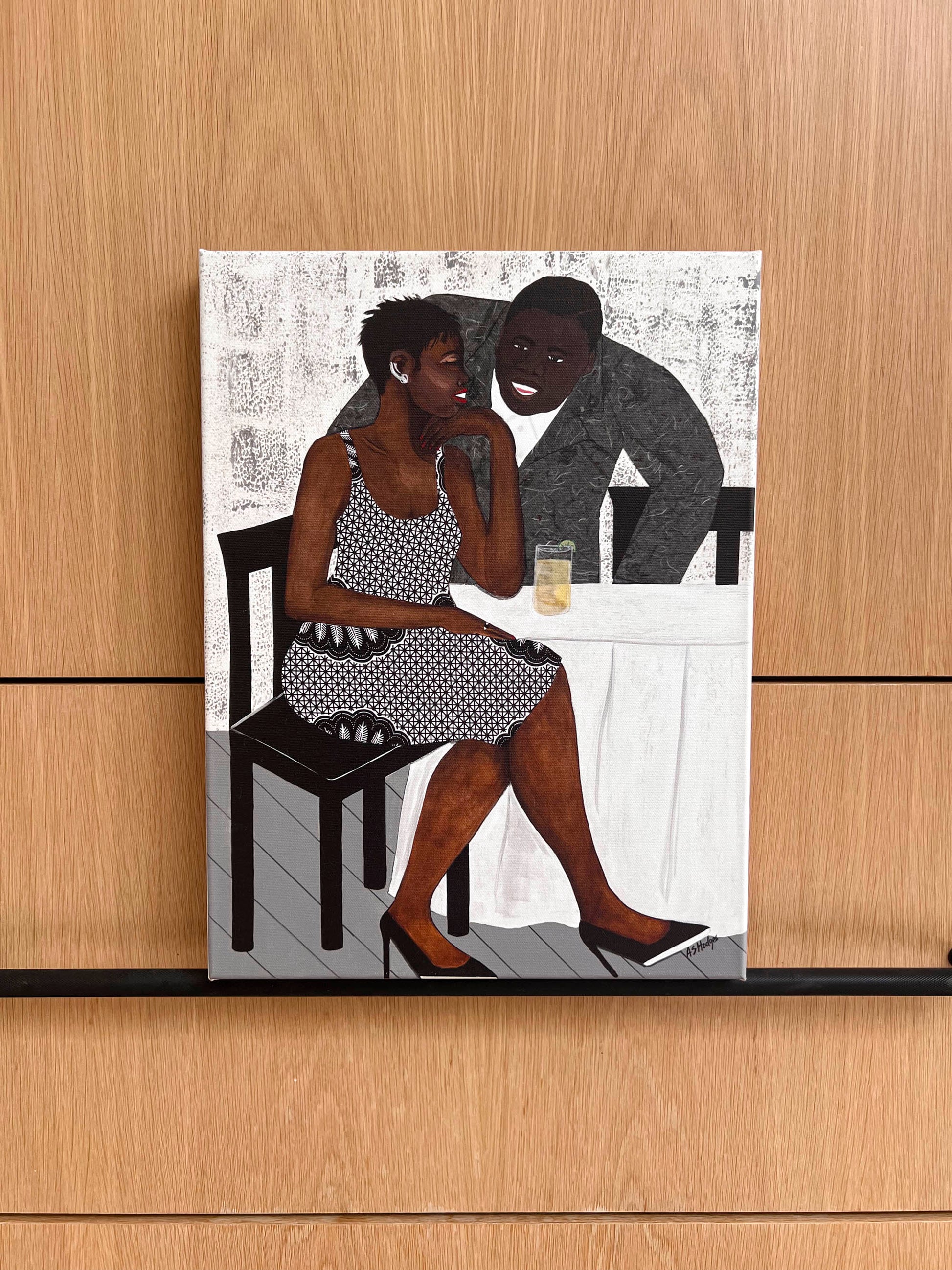 'The Conversation' fine art print: A couple engaged in an intimate dialogue, with the woman in an African-inspired print dress and the man in a gray jacket, set against a warm-toned background.  shown printed on stretched canvas