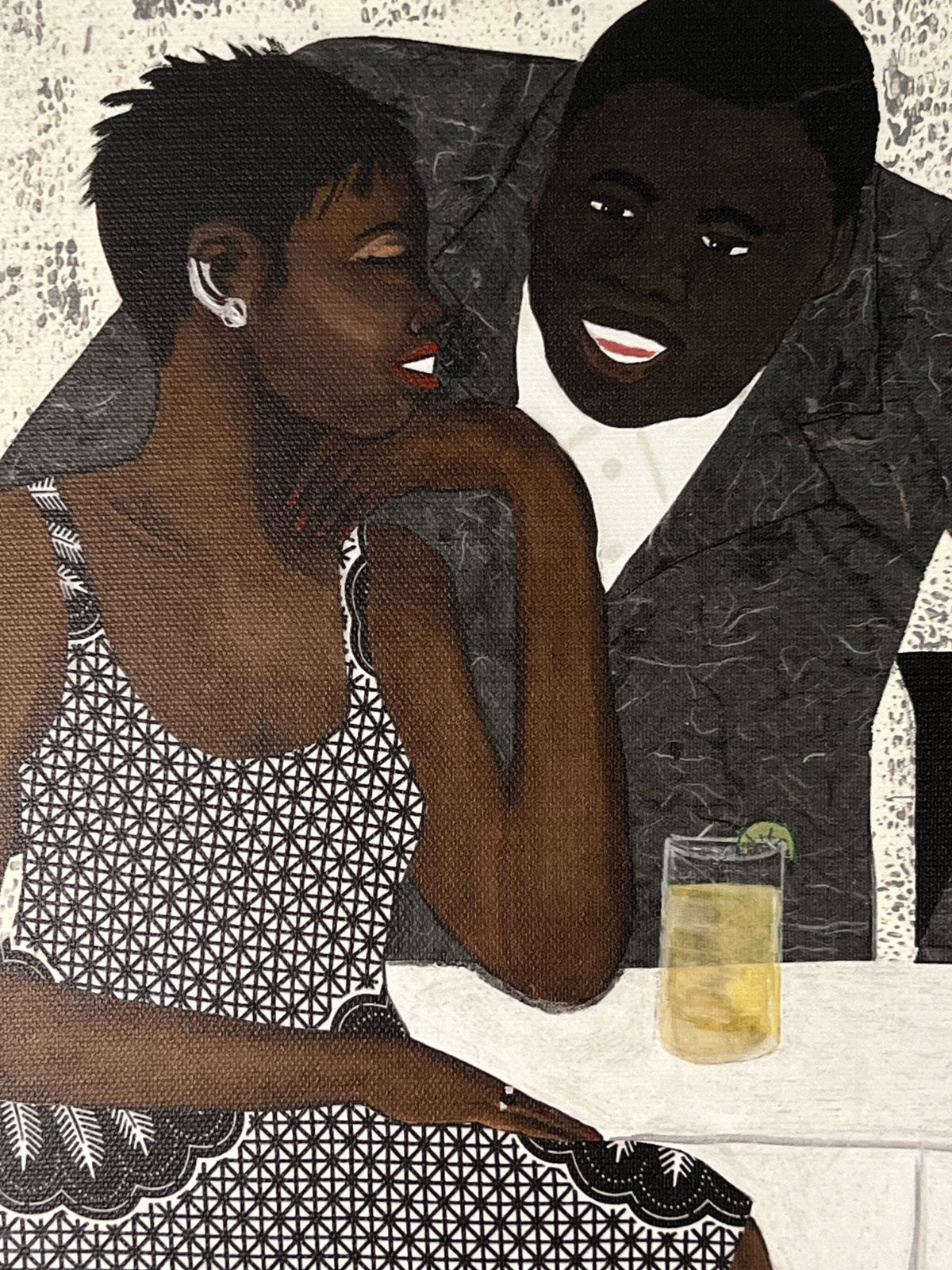 detail of 'The Conversation' stretched canvas print: A couple engaged in an intimate dialogue, with the woman in an African-inspired print dress and the man in a gray jacket, set against a warm-toned background.