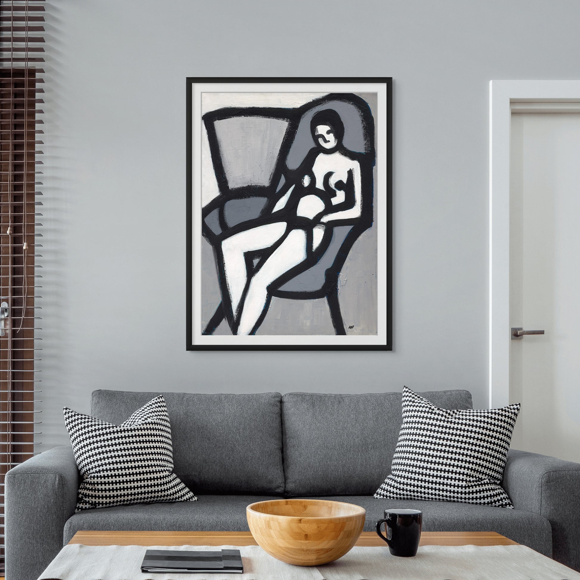 Black artist Antionette Simmons Hodges painting titled The Model. Shown as a framed fine art print. This is a black and white painting showing a seated female figure nude.