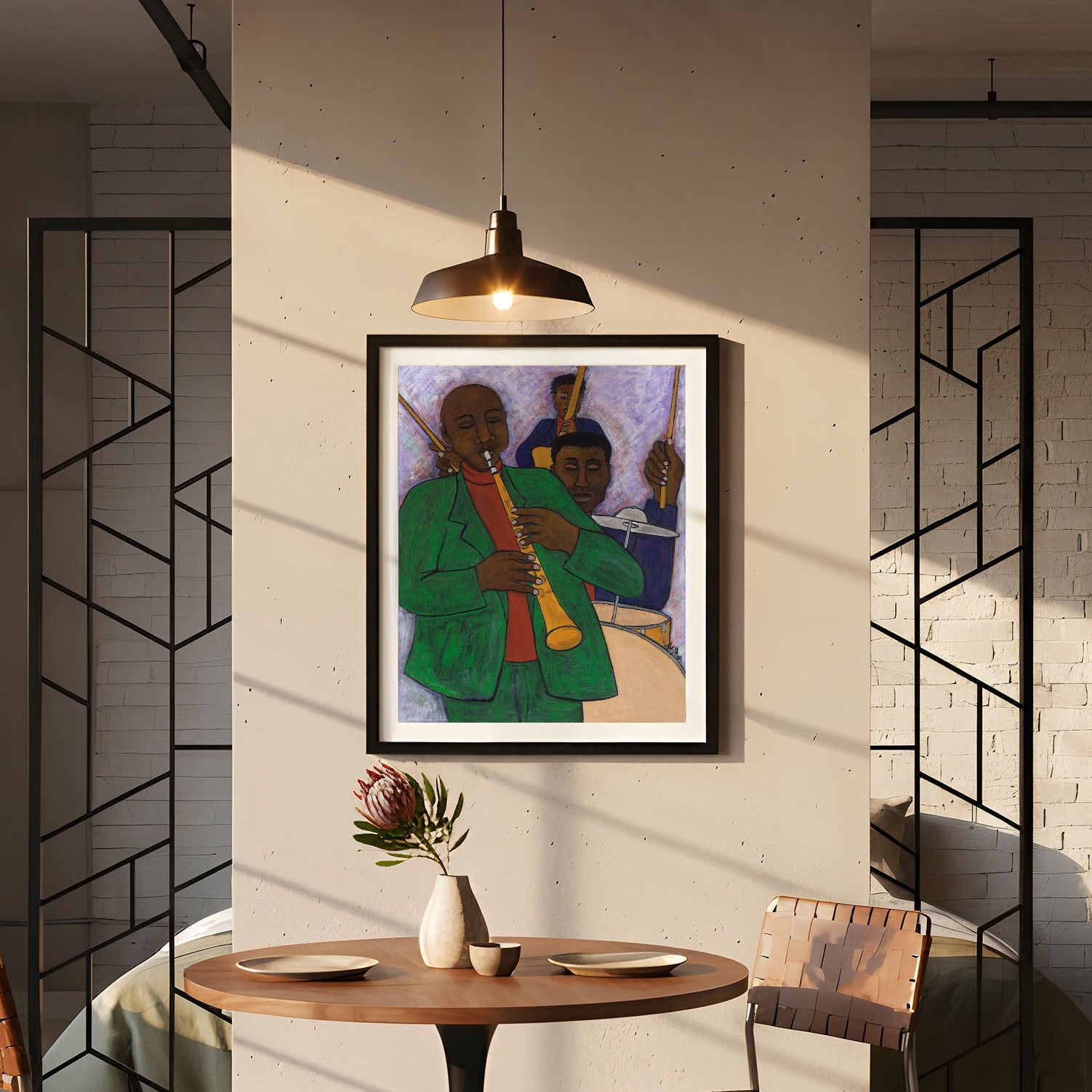 Modern interior with a dining table and chairs, framed  jazz band artwork on the wall, and a bookshelf.